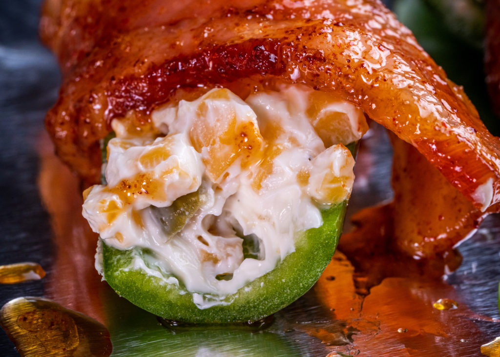 uncooked popper wrapped in candied bacon