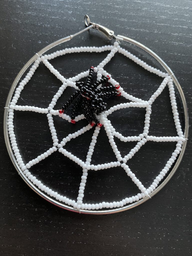 beaded hoop earring with a bead spider and web