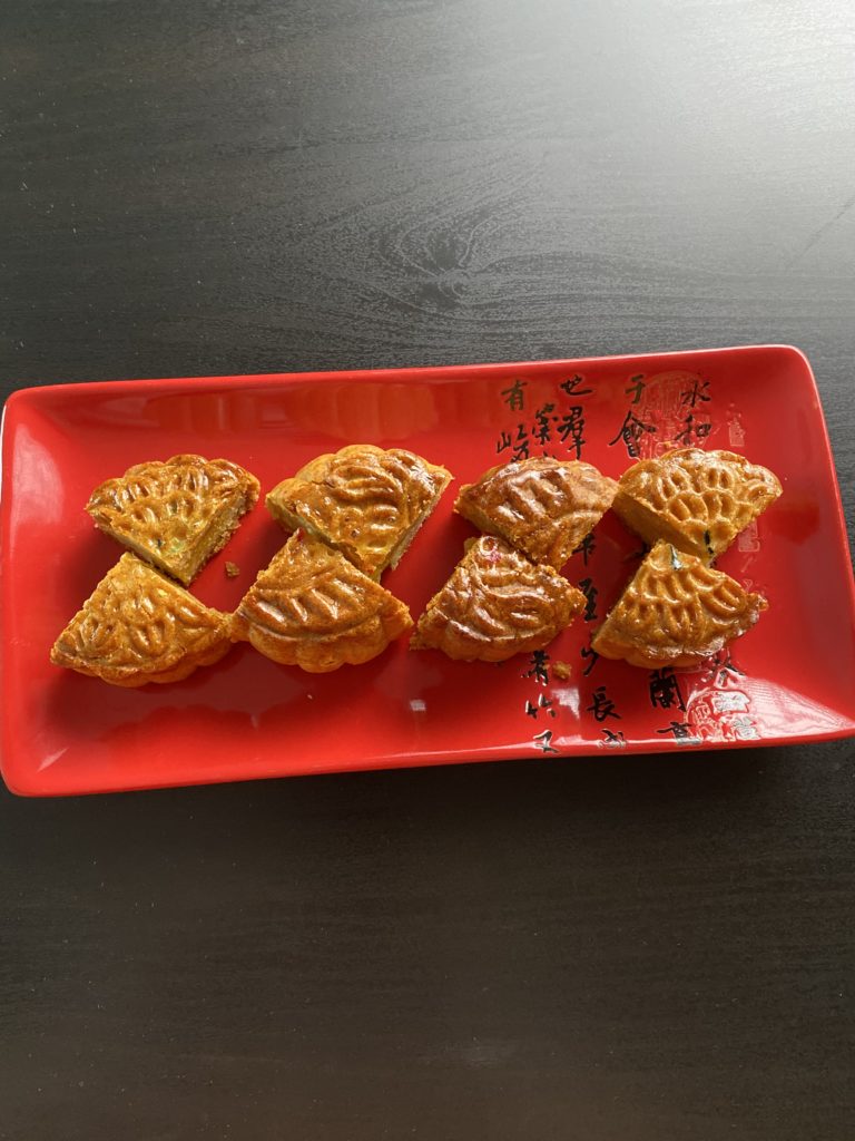 quartered mooncakes on a red plate