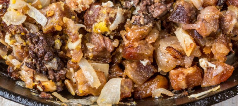 Sisig in a cast-iron pan
