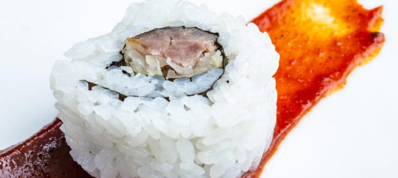 Currywurst sushi on a smear of curry sauce
