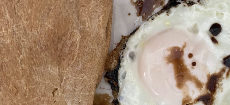 french bread with a fried egg and maggi sauce