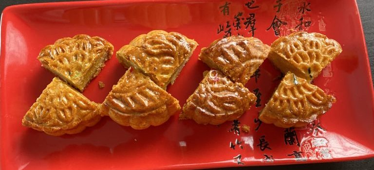 quartered mooncakes on a red plate