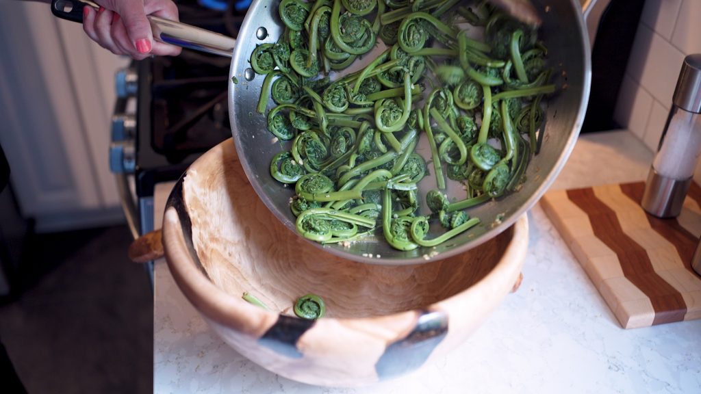 A bowl of sauteed fiddleheads